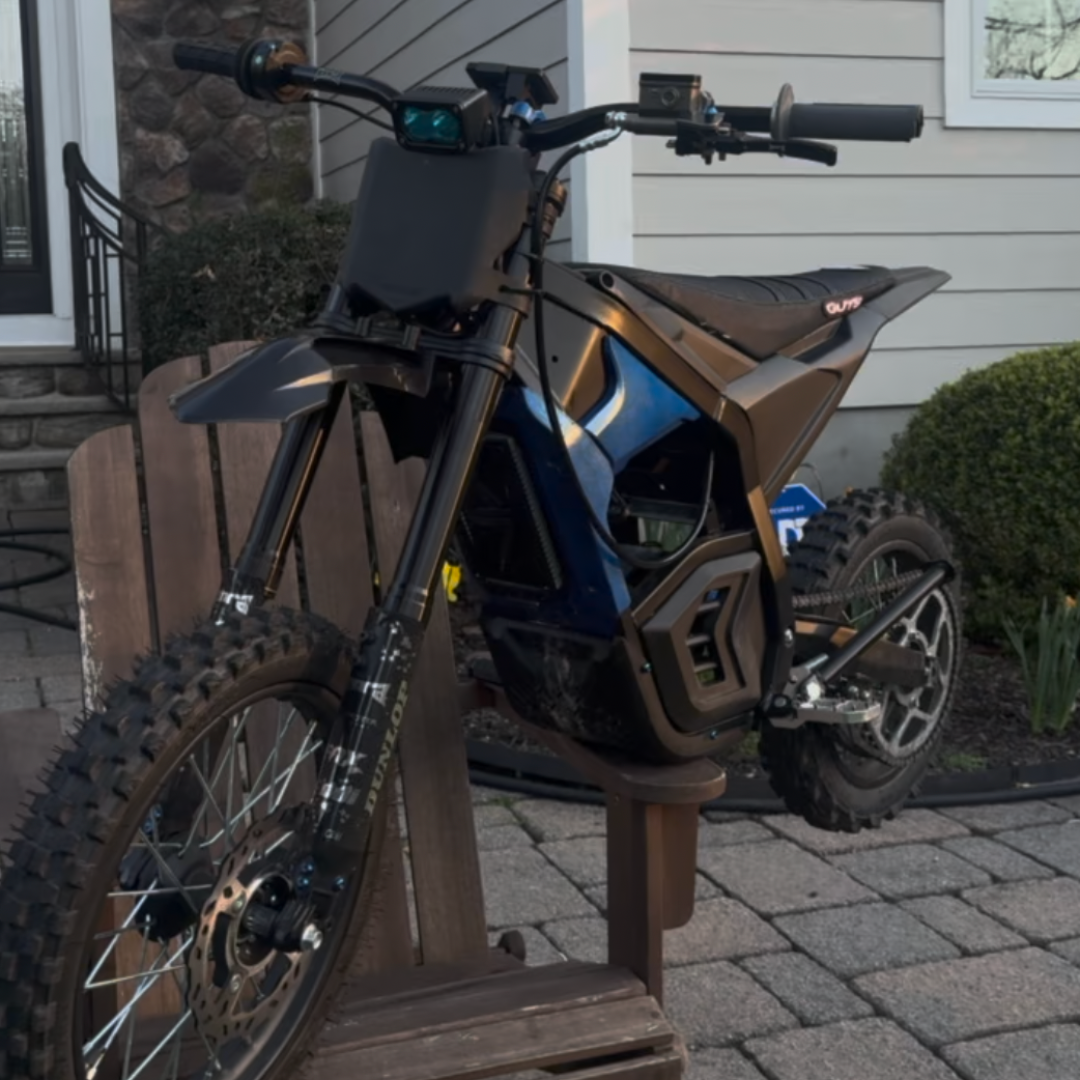 Black mini e-moto fender mounted on a bike