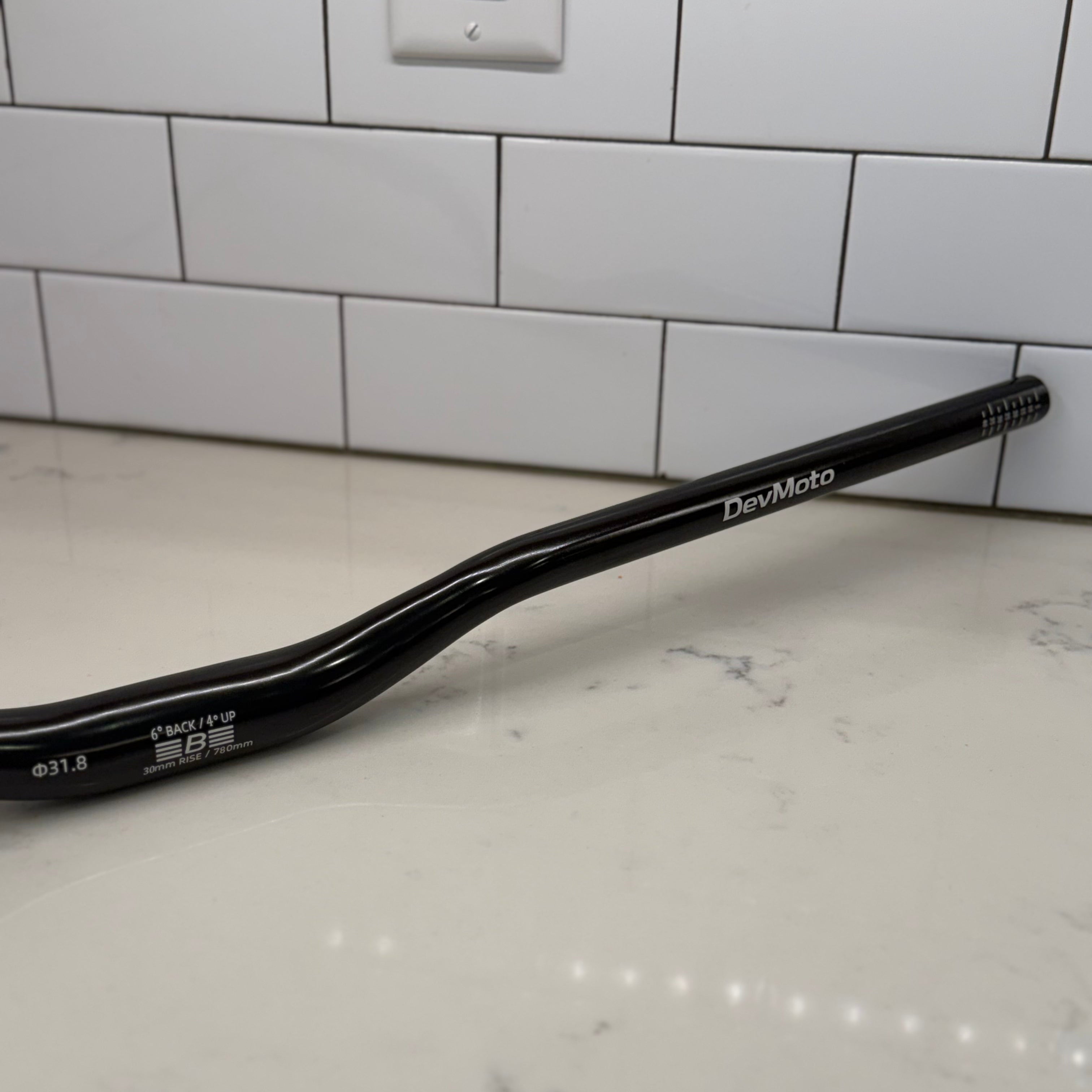 Glossy black e-moto handlebar finish detail